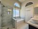 Modern bathroom featuring stylish shower, and separate soaking tub at 1463 E Silver Creek Rd, Gilbert, AZ 85296