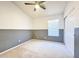 Bright bedroom with neutral carpeting, a ceiling fan, and a large window at 1463 E Silver Creek Rd, Gilbert, AZ 85296