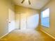 Bright bedroom with a ceiling fan, neutral walls and carpeting, and closet for storage at 1463 E Silver Creek Rd, Gilbert, AZ 85296