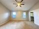 Comfortable bedroom featuring a ceiling fan, plush carpeting, dual windows, and a convenient walk-in closet at 1463 E Silver Creek Rd, Gilbert, AZ 85296