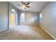The spacious main bedroom boasts neutral walls, arched windows, a ceiling fan, and plush carpet, creating a tranquil retreat at 1463 E Silver Creek Rd, Gilbert, AZ 85296
