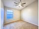 Well-lit bedroom with a ceiling fan, neutral walls and carpeting, and a window at 1463 E Silver Creek Rd, Gilbert, AZ 85296