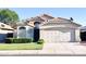 Inviting single-Gathering home showcases a two-car garage, verdant lawn, and trimmed hedges beneath a clear blue sky at 1463 E Silver Creek Rd, Gilbert, AZ 85296
