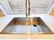 A deep stainless steel kitchen sink is featured beneath a window, highlighting its modern design and functionality at 1463 E Silver Creek Rd, Gilbert, AZ 85296
