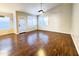 Open living area with hardwood flooring, bright windows, and a ceiling fan provides a welcoming space for relaxation and entertainment at 1463 E Silver Creek Rd, Gilbert, AZ 85296