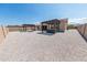 This backyard features a patio cover, a built-in hot tub and barbecue area, neutral gravel, and a fenced perimeter at 15248 S 182Nd Ln, Goodyear, AZ 85338