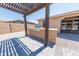 This backyard features a patio cover, a built-in stainless steel barbecue, with brick pavers and neutral gravel at 15248 S 182Nd Ln, Goodyear, AZ 85338