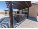 This backyard features a patio cover, with a built-in hot tub, and neutral gravel at 15248 S 182Nd Ln, Goodyear, AZ 85338