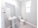 Charming powder room featuring a pedestal sink and tiled floor at 15248 S 182Nd Ln, Goodyear, AZ 85338
