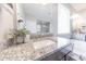 Elegant bathroom featuring granite countertops, dual sinks, a soaking tub, and a glass-enclosed shower at 15248 S 182Nd Ln, Goodyear, AZ 85338
