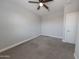 Neutral-toned bedroom featuring a ceiling fan and plush carpet at 15248 S 182Nd Ln, Goodyear, AZ 85338