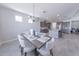 Bright dining area featuring a stylish chandelier and an open floor plan with views into the gourmet kitchen at 15248 S 182Nd Ln, Goodyear, AZ 85338
