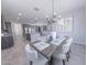 Open-concept dining area with modern lighting, seamlessly connected to the kitchen and living spaces at 15248 S 182Nd Ln, Goodyear, AZ 85338