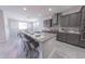 Modern kitchen featuring a large island, granite countertops, stainless steel appliances, and bar seating at 15248 S 182Nd Ln, Goodyear, AZ 85338