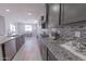 Gourmet kitchen with stainless steel appliances, granite countertops, tile backsplash and open dining area at 15248 S 182Nd Ln, Goodyear, AZ 85338