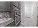 Close-up of the double ovens and tile backsplash in this modern kitchen with stainless steel appliances at 15248 S 182Nd Ln, Goodyear, AZ 85338