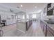 Open-concept kitchen featuring a large island, stainless steel appliances, and seamless transition to living spaces at 15248 S 182Nd Ln, Goodyear, AZ 85338