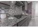 Updated kitchen features granite countertops, mosaic tile backsplash and stainless steel appliances at 15248 S 182Nd Ln, Goodyear, AZ 85338