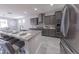 Modern kitchen with granite countertops, stainless steel appliances, a kitchen island, and open dining area at 15248 S 182Nd Ln, Goodyear, AZ 85338