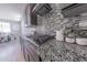 Modern kitchen features granite countertops, stainless steel appliances, and a stylish mosaic tile backsplash at 15248 S 182Nd Ln, Goodyear, AZ 85338