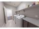 Bright laundry room with stainless steel appliances and convenient shelving at 15248 S 182Nd Ln, Goodyear, AZ 85338