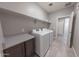 A practical laundry room featuring modern washer and dryer with a sleek countertop at 15248 S 182Nd Ln, Goodyear, AZ 85338
