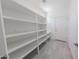 Large pantry with white shelving offering ample storage, next to the kitchen area at 15248 S 182Nd Ln, Goodyear, AZ 85338