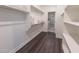 Well-organized walk-in closet with dark floors and open shelving for ample storage at 15248 S 182Nd Ln, Goodyear, AZ 85338