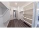 Spacious walk-in closet with ample shelving and hanging space for organized storage and easy access at 15248 S 182Nd Ln, Goodyear, AZ 85338
