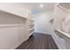 Organized walk-in closet featuring built-in shelving, hanging racks, and modern lighting for convenience at 15248 S 182Nd Ln, Goodyear, AZ 85338