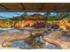 Backyard with pool, fire pit, and lush landscaping, perfect for outdoor entertaining at 17728 N 92Nd Pl, Scottsdale, AZ 85255