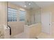 Walk-in shower with a glass enclosure, dual shower heads, and glass block windows in modern bathroom at 17728 N 92Nd Pl, Scottsdale, AZ 85255