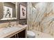 Bathroom featuring a marble walk in shower with a modern design and a beautifully framed wall art at 17728 N 92Nd Pl, Scottsdale, AZ 85255