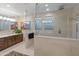 Bathroom featuring a glass walk in shower and a double vanity with lots of natural light at 17728 N 92Nd Pl, Scottsdale, AZ 85255