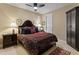 Well-lit bedroom with a patterned bedspread, dark wood furniture, and a ceiling fan at 17728 N 92Nd Pl, Scottsdale, AZ 85255