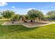 Wide view of community playground with various play structures and green spaces at 17728 N 92Nd Pl, Scottsdale, AZ 85255