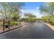 A gated entrance with lush greenery and trees, adding to the private feel of this property at 17728 N 92Nd Pl, Scottsdale, AZ 85255