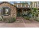 Charming stone house featuring a quaint porch and desert landscaping, creating a welcoming curb appeal at 17728 N 92Nd Pl, Scottsdale, AZ 85255