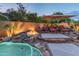 Backyard fire feature with seating and stone accents, creating a cozy outdoor space at 17728 N 92Nd Pl, Scottsdale, AZ 85255