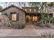 Charming stone-clad home with a cozy front porch and well-manicured desert landscaping at 17728 N 92Nd Pl, Scottsdale, AZ 85255