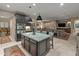 Modern kitchen featuring a large island with stone countertop and dark cabinetry at 17728 N 92Nd Pl, Scottsdale, AZ 85255