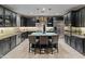 Modern kitchen featuring black cabinets, stainless steel appliances, granite countertops, and pendant lighting at 17728 N 92Nd Pl, Scottsdale, AZ 85255