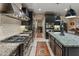 Modern kitchen with stone countertops, professional-grade appliances, and open design at 17728 N 92Nd Pl, Scottsdale, AZ 85255