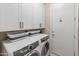 Clean and organized laundry room featuring modern appliances and ample storage cabinets at 17728 N 92Nd Pl, Scottsdale, AZ 85255