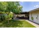Spacious backyard featuring a shaded pergola, a hot tub, and lush green turf offers relaxation at 1861 W Navarro Ave, Mesa, AZ 85202