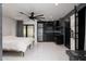 Combined living space featuring a bedroom, stainless steel refrigerator, and a modern kitchenette at 1861 W Navarro Ave, Mesa, AZ 85202