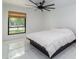 Sunlit bedroom showcases a large window and inviting bed, set against stylish tile floors at 1861 W Navarro Ave, Mesa, AZ 85202