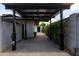 Contemporary carport featuring sleek design, concrete flooring, and lush landscaping for added curb appeal at 1861 W Navarro Ave, Mesa, AZ 85202