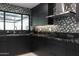 Modern kitchen with dark cabinetry, stainless steel range hood, mosaic backsplash, and granite countertops at 1861 W Navarro Ave, Mesa, AZ 85202