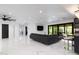 Bright living room with sleek tile flooring, modern decor, and a seamless flow into adjacent spaces at 1861 W Navarro Ave, Mesa, AZ 85202